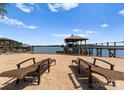 Private beach featuring lounge chairs and a covered dock, offering serene waterfront relaxation at 3988 Channel Point Ln, Denver, NC 28037