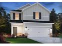Beautiful exterior view of a bright two-story home with a two car garage and newly installed landscaping at 4325 Summit Woods Dr, Charlotte, NC 28216