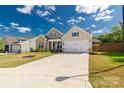 Charming single-Gathering home featuring a manicured lawn, and a large drive leading to a 2-car garage at 5119 Moselle Ave, Fort Mill, SC 29707