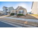 Inviting curb appeal with landscaped front yard, sidewalk, and craftsman-style architecture in residential neighborhood at 530 Kiser Ln, Locust, NC 28097