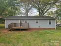 Back of home featuring a wooden deck with railing and gray siding at 5319 Springdale Ave, Mint Hill, NC 28227