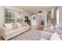 Spacious living room with modern decor, light-colored walls, hardwood floors, and a view of the entrance and staircase at 5329 Glenbrier Dr, Charlotte, NC 28212