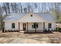 Inviting home with a covered porch supported by timber pillars, creating a cozy and welcoming entrance at 676 Chapel Hill Dr, Troy, NC 27371