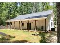 The rear of the house shows the covered back porch and outdoor living space at 676 Chapel Hill Dr, Troy, NC 27371