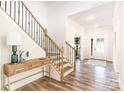 Elegant foyer with hardwood floors, staircase with iron spindles, and a stylish console table at 7001 New Town Rd, Waxhaw, NC 28173