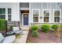 Welcoming home with well maintained front yard featuring stone accents and outdoor seating area at 1112 Drummond Ave, Charlotte, NC 28205