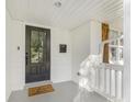 Inviting front porch with black front door, 'Welcome Home' mat, and a glimpse of the home's exterior at 1210 Sewickley Dr, Charlotte, NC 28209