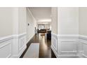 Welcoming hallway featuring elegant wainscoting, hardwood floors and a view into the open-concept living space at 1212 Croft Dr, Fort Mill, SC 29708