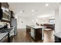 Modern kitchen with stainless steel appliances, a large center island, and an open view of the living area at 1212 Croft Dr, Fort Mill, SC 29708