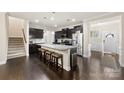Open-concept kitchen boasting a large island with seating, modern appliances, and dark wood cabinetry at 1212 Croft Dr, Fort Mill, SC 29708