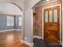 Inviting foyer with arched doorways, hardwood floors, and a decorative front door at 1220 Oakwood Ave, Gastonia, NC 28052