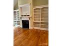 Living room featuring hardwood floors, fireplace and built in shelving at 127 Victoria Park Dr, Shelby, NC 28150