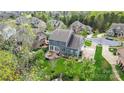 Rear aerial view of a home featuring a deck, landscaped yard, and a patio at 13713 Sunset Bluffs Cir, Huntersville, NC 28078