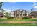 Beautiful two-story home with a manicured front yard and a side-entry garage at 13713 Sunset Bluffs Cir, Huntersville, NC 28078