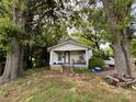 Inviting single-story home nestled amongst mature trees, featuring a cozy front porch at 142 26Th Sw St, Hickory, NC 28602