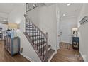 Welcoming entryway with hardwood floors, staircase with iron spindles, and a view of the front door at 15122 Lake Ridge Rd, Charlotte, NC 28278