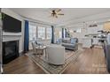 Bright and airy living room features hardwood floors, fireplace and windows, with an open view to the kitchen at 15122 Lake Ridge Rd, Charlotte, NC 28278
