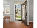 Inviting entryway featuring hardwood floors, white trim, and a view to the living spaces at 1528 Ridge Haven Rd, Waxhaw, NC 28173
