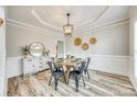 Dining room featuring wood floors, decorative trim, and a stylish chandelier at 1813 Robbins Meadows Dr, Waxhaw, NC 28173