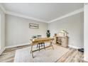 Bright home office features wood floors, a desk, chair and ample natural light at 1813 Robbins Meadows Dr, Waxhaw, NC 28173