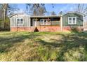 Charming exterior of a cozy home featuring a quaint porch and a brick foundation at 205 Jim Patterson Rd, Kings Mountain, NC 28086
