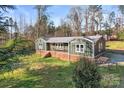 Exterior view of a home with a inviting porch and well-maintained landscaping at 205 Jim Patterson Rd, Kings Mountain, NC 28086
