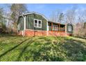 Exterior of a cozy home featuring a quaint porch and a brick foundation at 205 Jim Patterson Rd, Kings Mountain, NC 28086