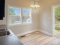 Cozy dining area showcases great natural light, wood flooring, and updated lighting at 2210 22Nd Avenue Se Ct, Hickory, NC 28602