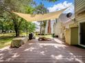 Large wooden deck with a shade, ideal for outdoor dining and entertaining with ample space at 2248 Lawton Bluff Rd, Charlotte, NC 28226