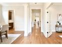 Open hallway featuring hardwood floors, white trim, and arched doorways at 2415 Christenbury Hall Nw Dr, Concord, NC 28027
