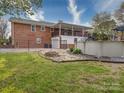 This home's backyard features a fire pit, fenced yard, and an elevated porch with stairs at 24436 Nc 24/27 Hwy, Albemarle, NC 28001