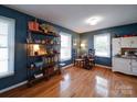 Bright living area boasts hardwood floors, decorative shelving, and views into the adjoining kitchen space at 24436 Nc 24/27 Hwy, Albemarle, NC 28001