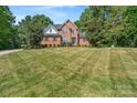 Beautiful brick home with a large front yard, offering classic curb appeal at 255 Honeysuckle Creek Loop, Mooresville, NC 28117