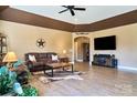 Spacious living room featuring hardwood floors and a tray ceiling with a western decor at 28926 Hartsell Rd, Albemarle, NC 28001
