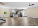 Open-concept kitchen and living area with stainless appliances, gray cabinets, center island, and wood-look flooring at 2948 Christy Leigh Dr, Newton, NC 28658