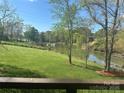 Green backyard lawn with lake view seen from the wooden deck at 307 Stillwater Rd, Troutman, NC 28166