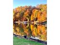 Scenic view of the lake surrounded by autumn trees with vibrant colors reflected on the water at 307 Stillwater Rd, Troutman, NC 28166