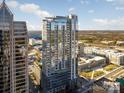Modern high-rise with reflective glass facade, pool deck, and city views under a bright sky at 333 W Trade St # 1802, Charlotte, NC 28202