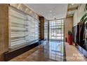 Elegant lobby with marble floors, water feature, and potted plants, creating a welcoming entrance at 333 W Trade St # 1802, Charlotte, NC 28202