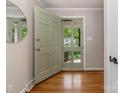 Entryway featuring hardwood floors and a lovely sage-green front door at 3911 Kitley Pl, Charlotte, NC 28210