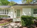 Welcoming front porch with painted brick, pastel door and mature landscaping at 3911 Kitley Pl, Charlotte, NC 28210