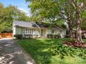 Inviting single-story home with well-maintained lawn and mature shade tree at 3911 Kitley Pl, Charlotte, NC 28210
