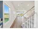 Inviting entryway boasting wood floors, complemented by natural light streaming through multiple windows and a staircase at 5016 Poplin Vly, Cherryville, NC 28021