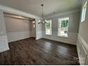 Open dining room featuring dark wood-look floors, large windows and elegant molding details at 5100 Verona Rd # 96, Charlotte, NC 28213