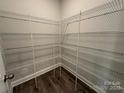 Walk-in pantry with white wire shelving and wood-look floors providing ample storage space at 5100 Verona Rd # 96, Charlotte, NC 28213