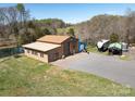 Spacious workshop near a pond, complete with a garage door, a smaller outbuilding, and room for parking at 7545 Brancy St, Kannapolis, NC 28081