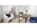 Stylish home office with a modern desk, accent chair, and French doors at 7730 Woolsey Dr, Gastonia, NC 28056