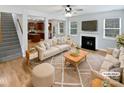 Bright living room with fireplace, hardwood floors, and view to kitchen create a warm, open space at 78162 Rillstone Dr, Lancaster, SC 29720