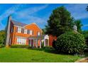 Charming brick home with a covered walkway and lush landscaping, creating a welcoming curb appeal at 1035 Pee Dee Ave, Albemarle, NC 28001