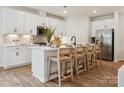 Bright modern kitchen featuring white cabinets, a subway tile backsplash, and stainless steel appliances at 1046 Mapletree Ln, Indian Trail, NC 28079